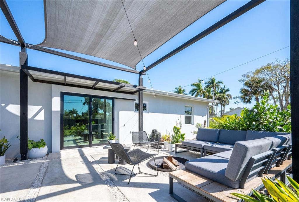 4608 Normandy Drive Naples, FL 34112 - Photo 26 of 49 a outdoor space with patio the couches and a potted plant on the wall