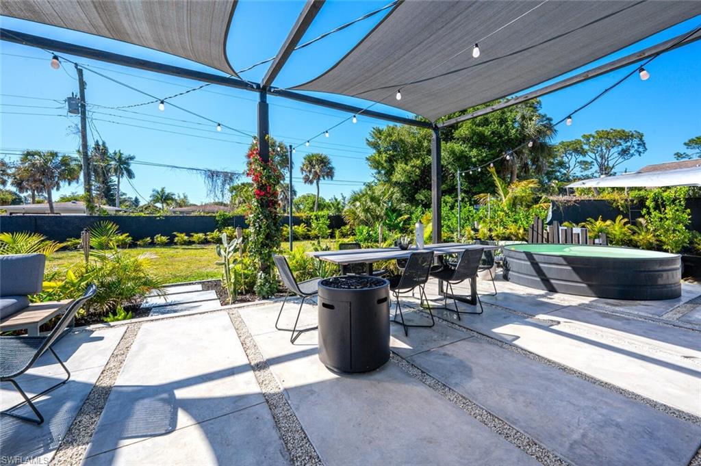 4608 Normandy Drive Naples, FL 34112 - Photo 27 of 49 a view of a patio with a dining table and chairs