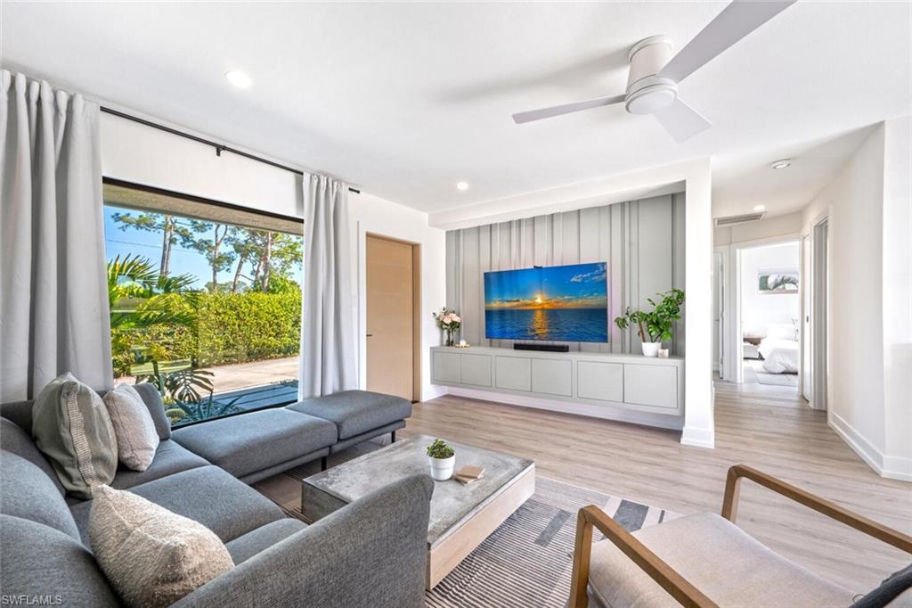 4608 Normandy Drive Naples, FL 34112 - Photo 3 of 49 a living room with furniture and a flat screen tv
