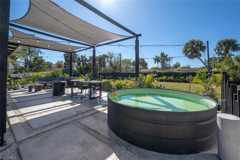 4608 Normandy Drive Naples, FL 34112 - Photo 35 of 49 a view of a swimming pool with a patio
