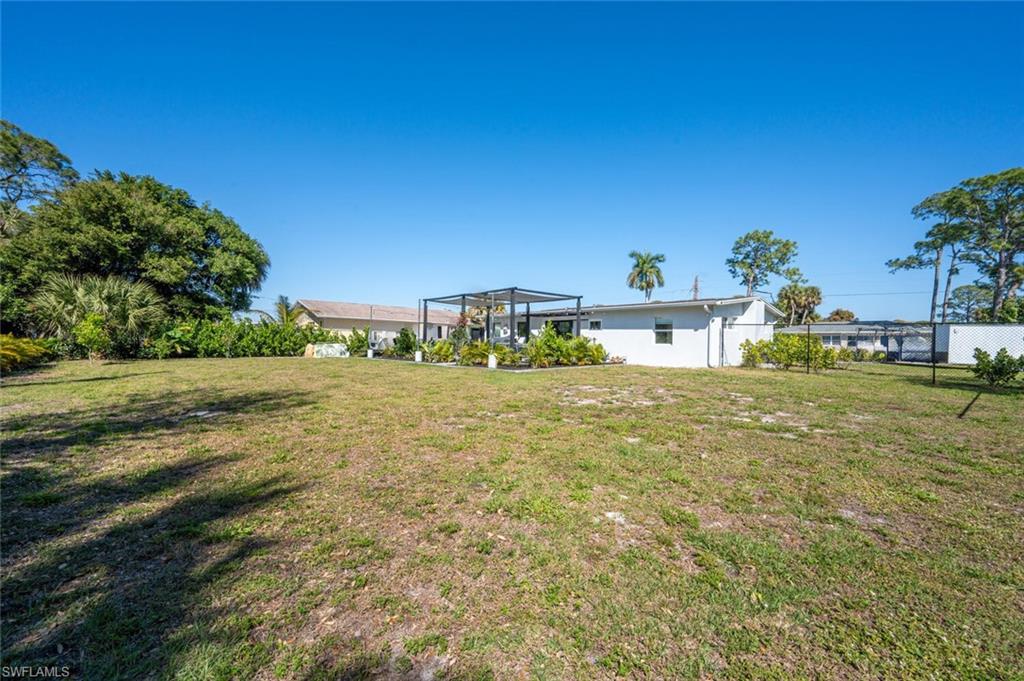 4608 Normandy Drive Naples, FL 34112 - Photo 40 of 49 a front view of a house with a yard