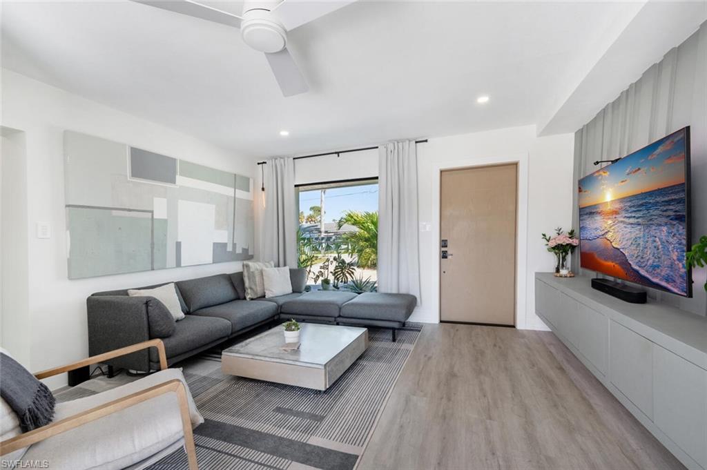 4608 Normandy Drive Naples, FL 34112 - Photo 4 of 49 a living room with furniture and a flat screen tv