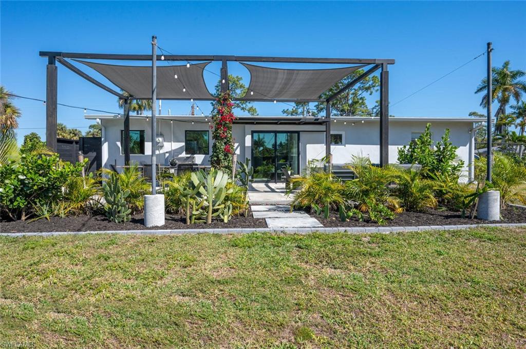 4608 Normandy Drive Naples, FL 34112 - Photo 42 of 49 front view of a house with a yard