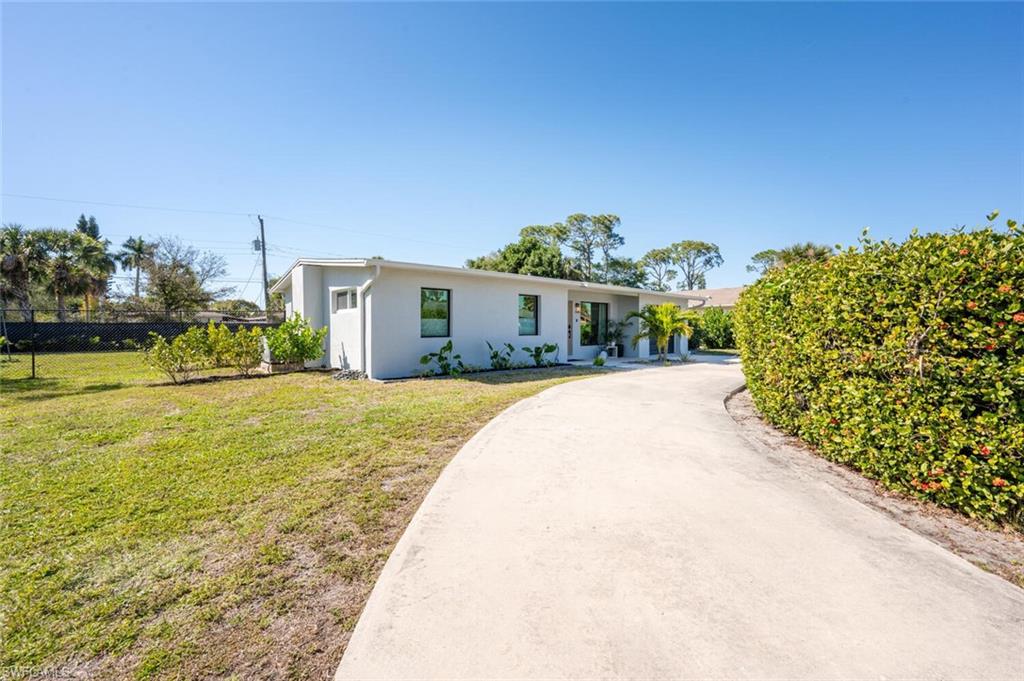 4608 Normandy Drive Naples, FL 34112 - Photo 44 of 49 a view of a house with a yard