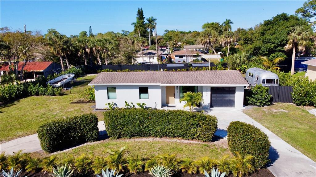 4608 Normandy Drive Naples, FL 34112 - Photo 46 of 49 a front view of a house with a garden