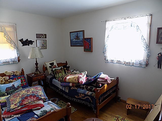 136 Beech Road Dingmans Ferry, PA 18328 - Photo 11 of 13 a bed room with furniture and a window