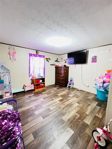 a spacious bedroom with a bed and a window