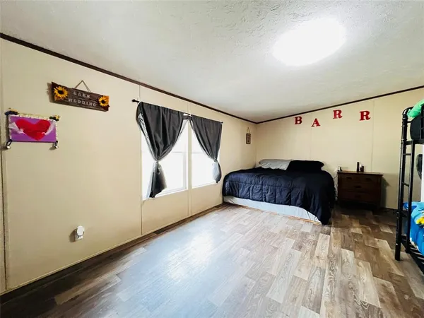 a bathroom with a granite countertop sink a toilet and a shower curtain