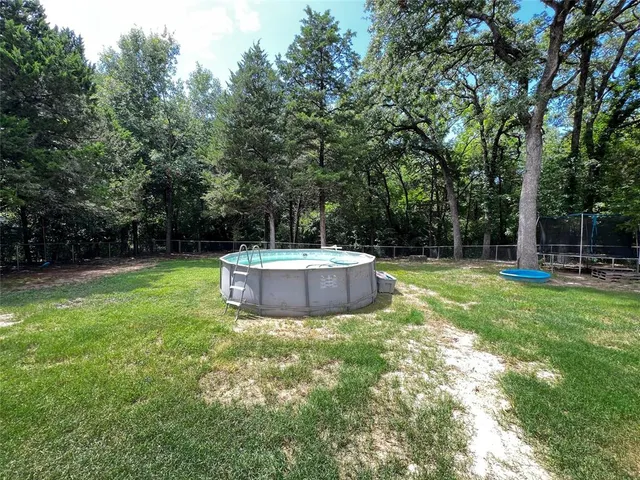 a backyard of a house with fire pit and outdoor seating