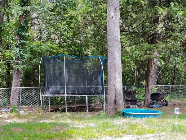 a view of a chair and table in the garden