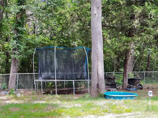 a view of a chair and table in the garden