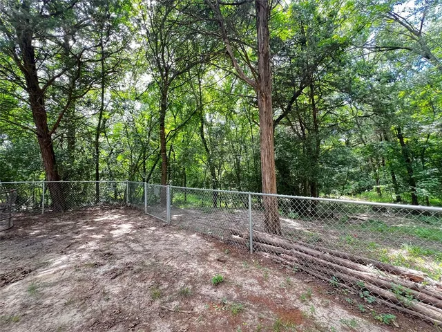 a backyard of a house with lots of trees