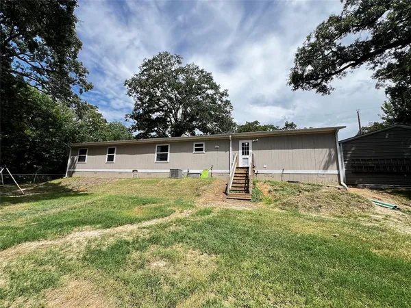 a white house that has a tree in it