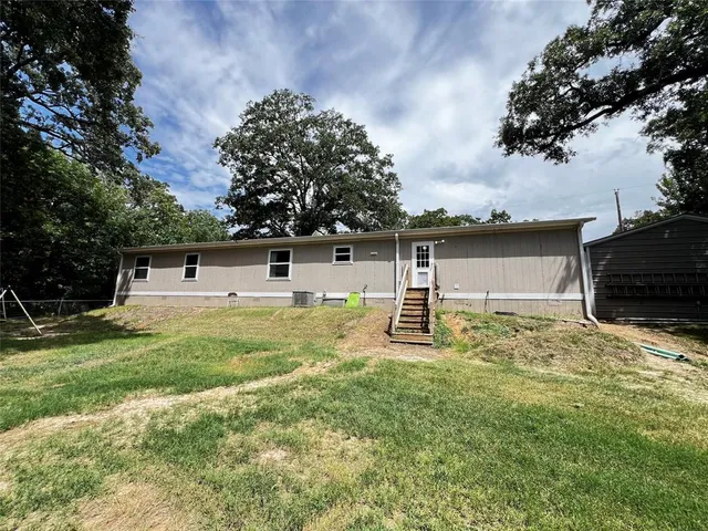 a white house that has a tree in it