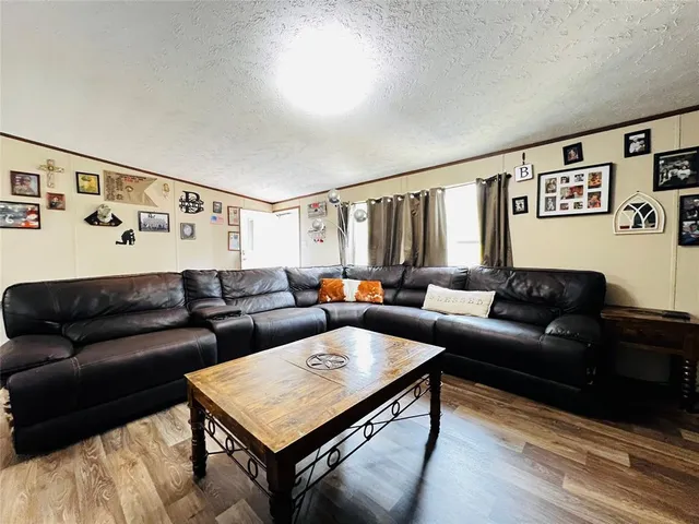 a living room with furniture and paintings on the wall