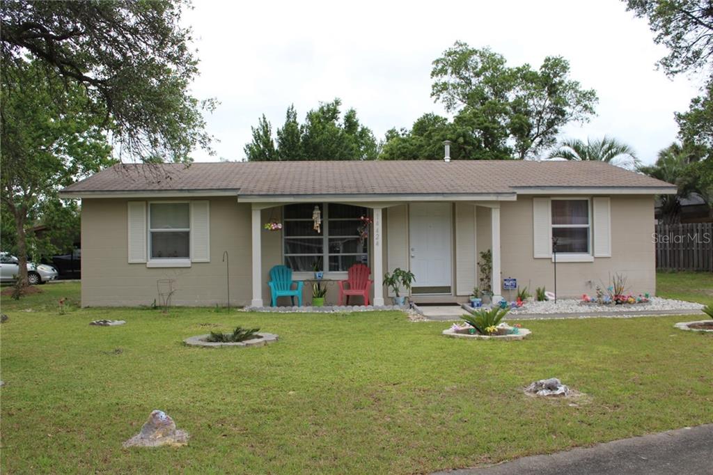 14424 Southwest 38th Terrace Road Ocala, FL 34473 - Photo 1 of 1 a front view of house with yard outdoor seating and green space
