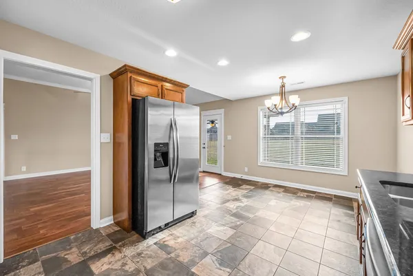 a view of an empty room with a fireplace and a window