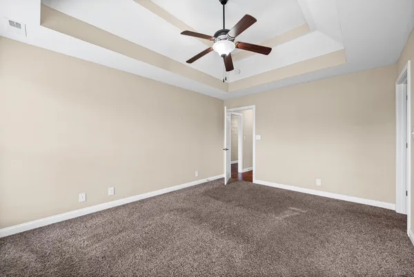 an empty room with a ceiling fan and a ceiling fan