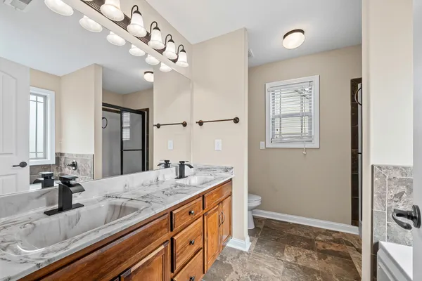 a bathroom with a sink a vanity and a large mirror