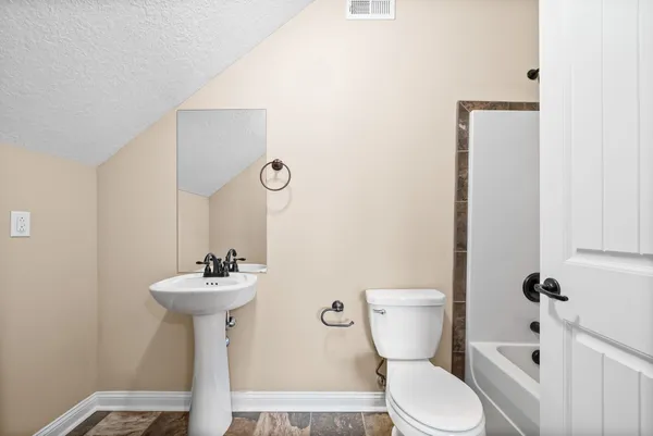 a bathroom with a sink a mirror and toilet