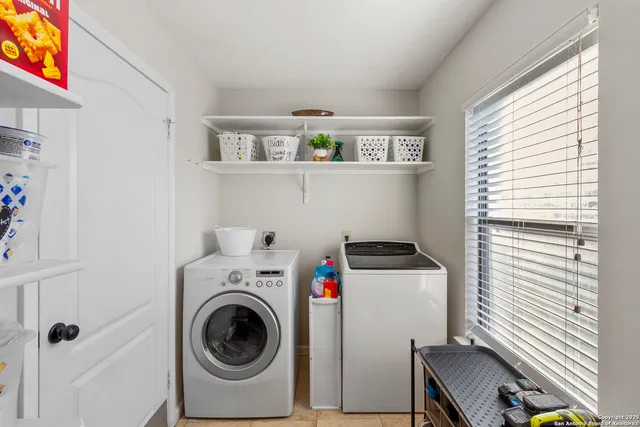 a utility room with dryer washer and a window