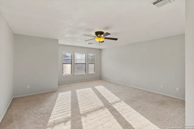 a view of an empty room and a window