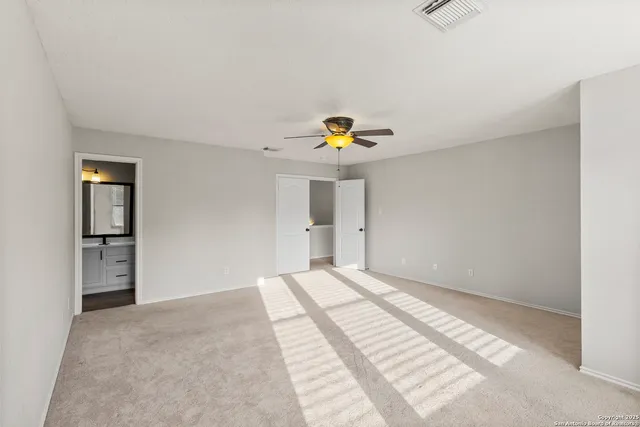 a view of a room with a ceiling fan