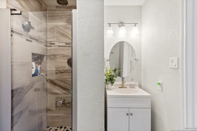 a bathroom with a sink and shower