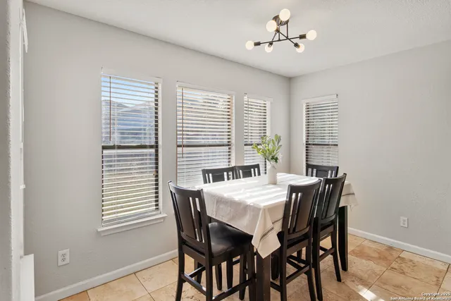 a view of a dining room with furniture and window