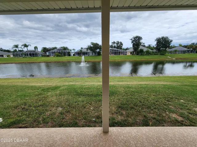 a view of a lake with houses in the background