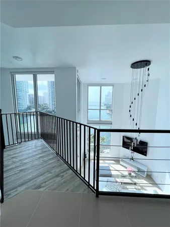 a living room with a bed furniture and a large window