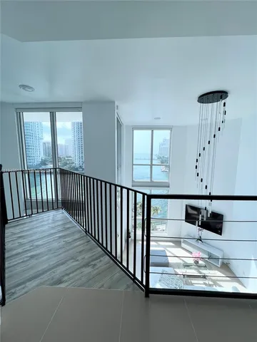 a living room with a bed furniture and a large window