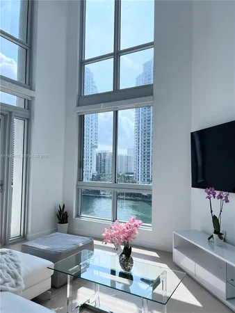 a living room with furniture and a chandelier