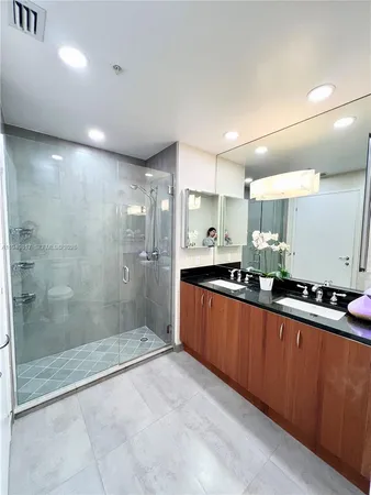 a large kitchen with stainless steel appliances lots of counter space and a sink
