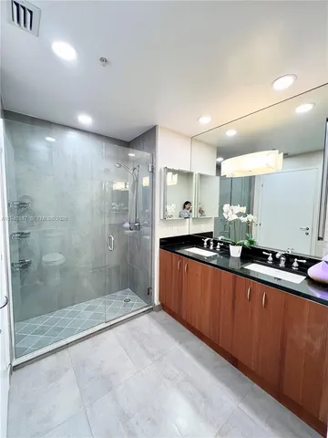 a large kitchen with stainless steel appliances lots of counter space and a sink