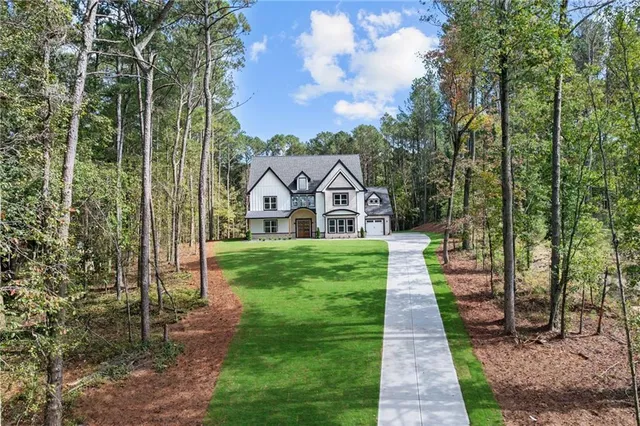 a view of a yard and front view of a house