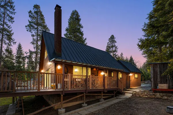 a view of backyard with deck and outdoor seating