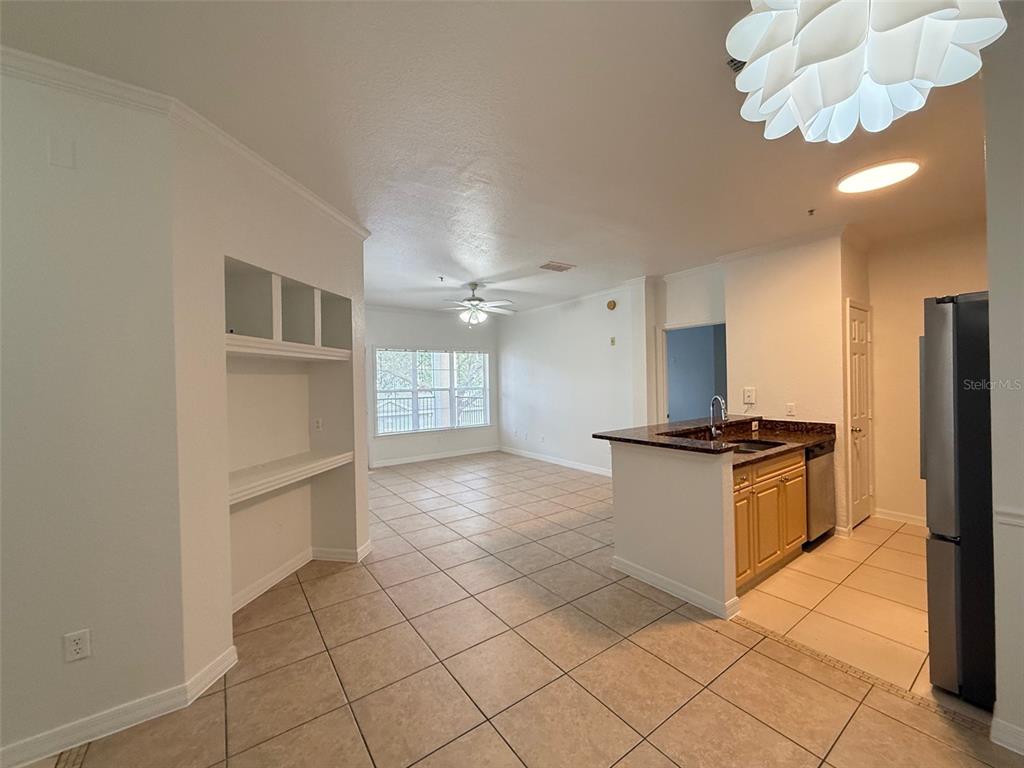 3611 Conroy Road, Unit 825 Orlando, FL 32839 - Photo 4 of 27 a kitchen with stainless steel appliances granite countertop a stove a sink and a refrigerator