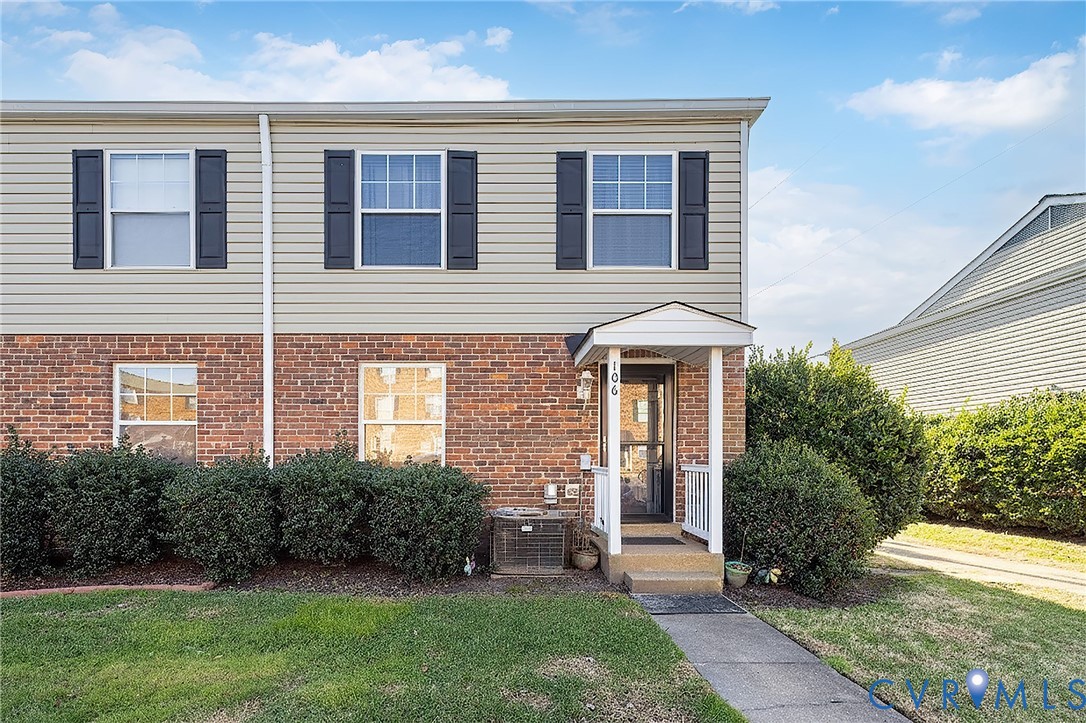 3520 East Richmond Road, Unit U106 Richmond, VA 23223 - Photo 2 of 18 Traditional-style house with a front yard and bric