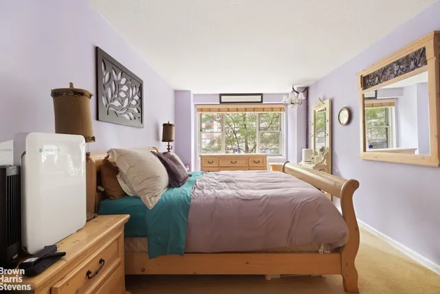 a bedroom with a bed and window
