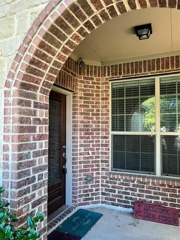 a view of a brick house with large windows
