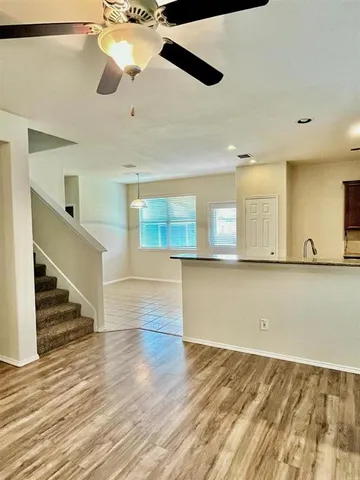 a view of an empty room and wooden floor
