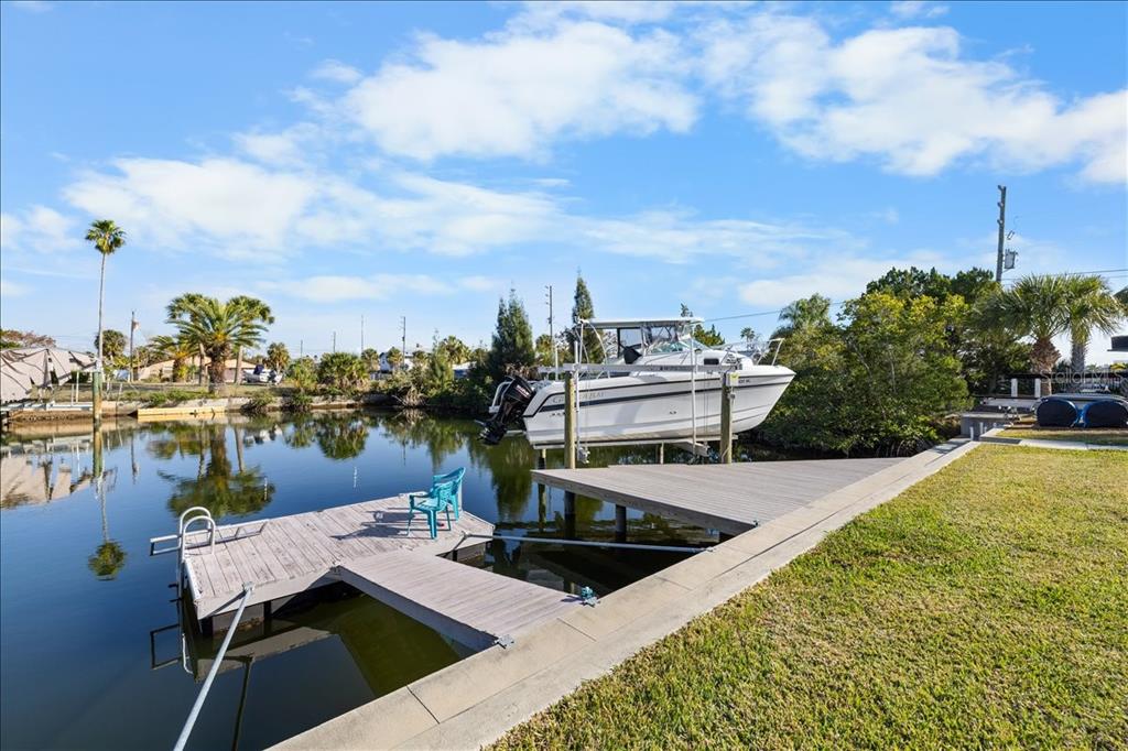 4452 Kingston Drive Hernando Beach, FL 34607 - Photo 1 of 47 a view of a swimming pool with seating area and lake view