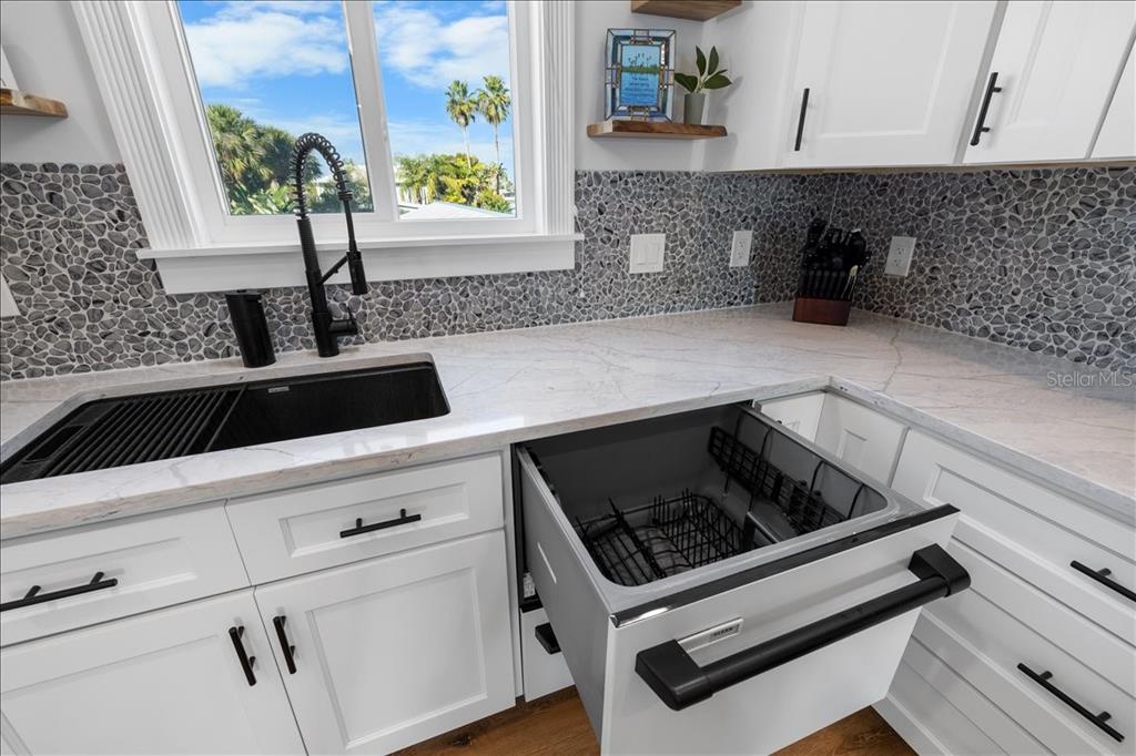 4452 Kingston Drive Hernando Beach, FL 34607 - Photo 14 of 47 a kitchen with a sink and cabinets