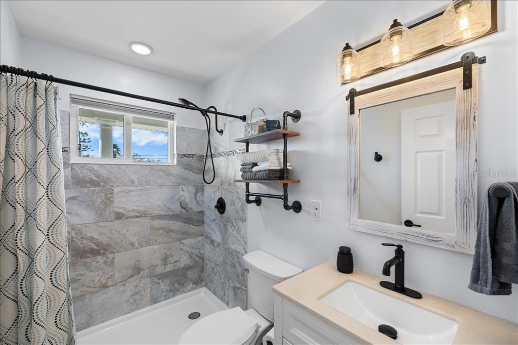 4452 Kingston Drive Hernando Beach, FL 34607 - Photo 28 of 47 a bathroom with a sink mirror and shower