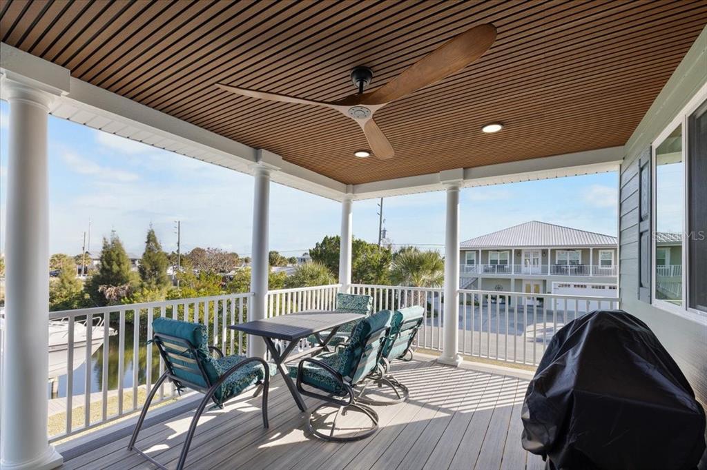4452 Kingston Drive Hernando Beach, FL 34607 - Photo 33 of 47 a view of a balcony with furniture and wooden floor