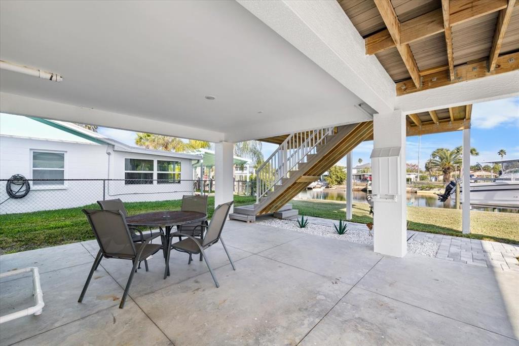 4452 Kingston Drive Hernando Beach, FL 34607 - Photo 36 of 47 a view of a patio with a table and chairs