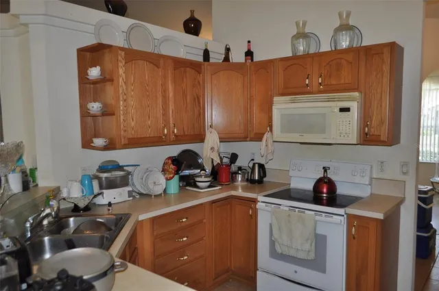 a kitchen with stainless steel appliances a sink a stove and cabinets
