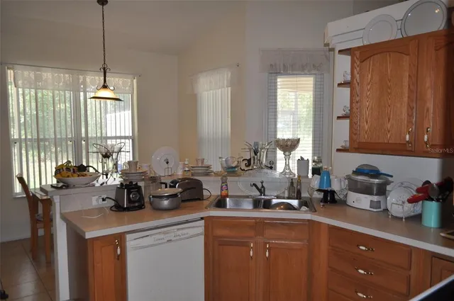a kitchen with a sink cabinets and window