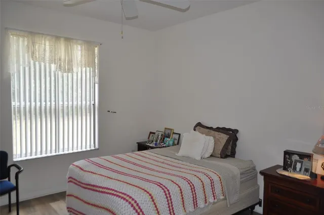 a bedroom with a bed and window